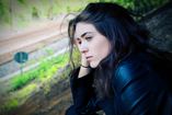 A woman struggles with thoughts of getting help for her alcohol addiction