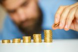 bearded man stacking coins