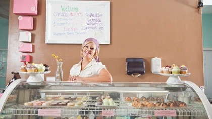A baker owner behind the counter.