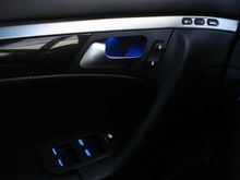 Driver side door with blue handle recess glow along with blue and white button illumination.