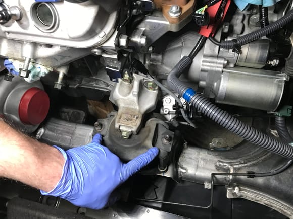 Remove those two bolts, x4 bolts connecting the mount to the subframe, and finally the single top bolt.
use a price od wood and an emergency jackstand under the oil pan to keep the engine in place.