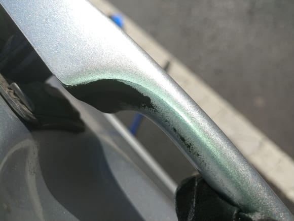 I wasn't mindful of the brake fluid on my hands and let this happen to my door handle.  Thankfully it's not a location with high visibility and I have touch-up paint.