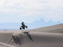 My son on 1988 LT500 at St Anthony sand dunes in Idaho with the Tetons in the background