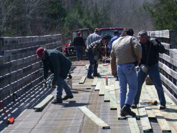 Volunteers redecking the Namakagon bridge on the Wild Rivers trail near Trego WI. Spring 2004