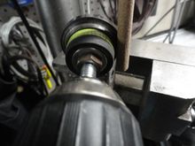 The set-up for the polishing, using a diameter specific split rod in my drill press with 220 grit paper, and the race secured in a high speed drill to make sure the race is polished uniformly.