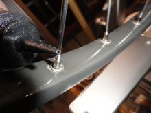 Oiling the spoke nipples to make tightening easier. 