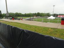 The view from the south looking west.  A couple of the teams are walking around the track outside the race surface.