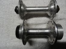 The hub logo is the early version of the Shimano logo and they are both the same logo.  