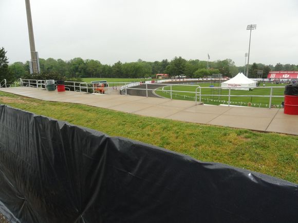 The view from the south looking west.  A couple of the teams are walking around the track outside the race surface.