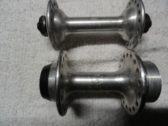 The hub logo is the early version of the Shimano logo and they are both the same logo.  
