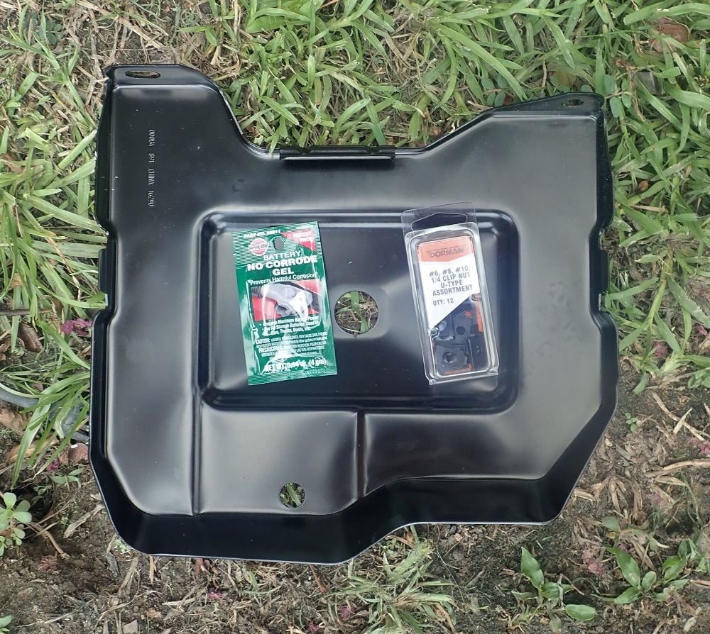In with the new battery tray. Pack of U-nuts on right, in a variety of sizes. Anti-corrosion battery grease on left, for the terminals.