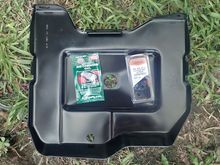 In with the new battery tray. Pack of U-nuts on right, in a variety of sizes. Anti-corrosion battery grease on left, for the terminals.