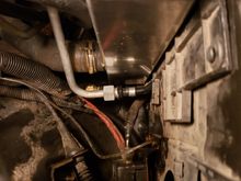 View showing how arm that holds one of the fittings for the AC condenser had to be bent so to not touch the new radiator.
 