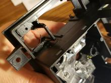 Looking from behind at the open body of the headlamp switch. Here the opening for the foglamp switch us at the top. The clear plastic ligh-guide is visible in the lower half of the image.