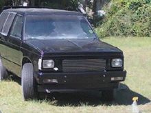 Grille shell, billet insert, bumper, and spoiler back on with clear lens installed.