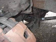 This is the best image showing how to get the ratchet on the nut for the rear bushing. I took it out with the ratchet on the back of the bolt (to the right).