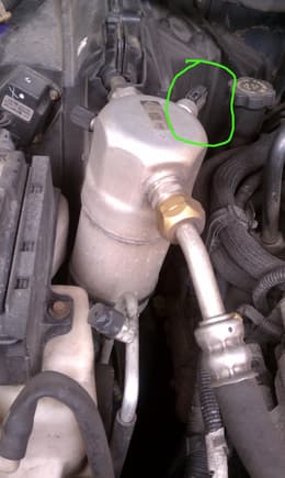 The AC clutch pressure switch is mounted to the accumulator and is circled.