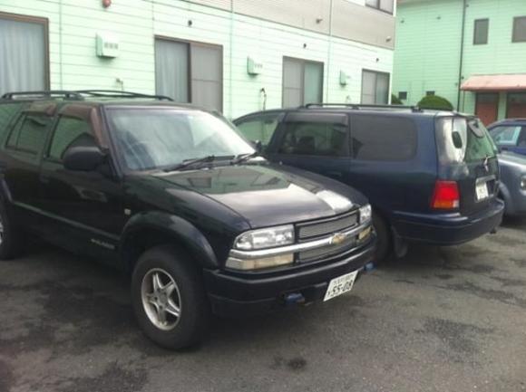 My Blazer awaiting repair(s), and to the right my $900 Honda Odyssey...