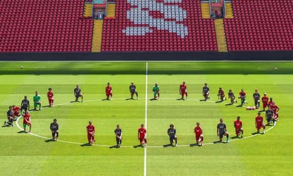 Liverpool players take a knee in memory of George Floyd at Anfield on Monday.