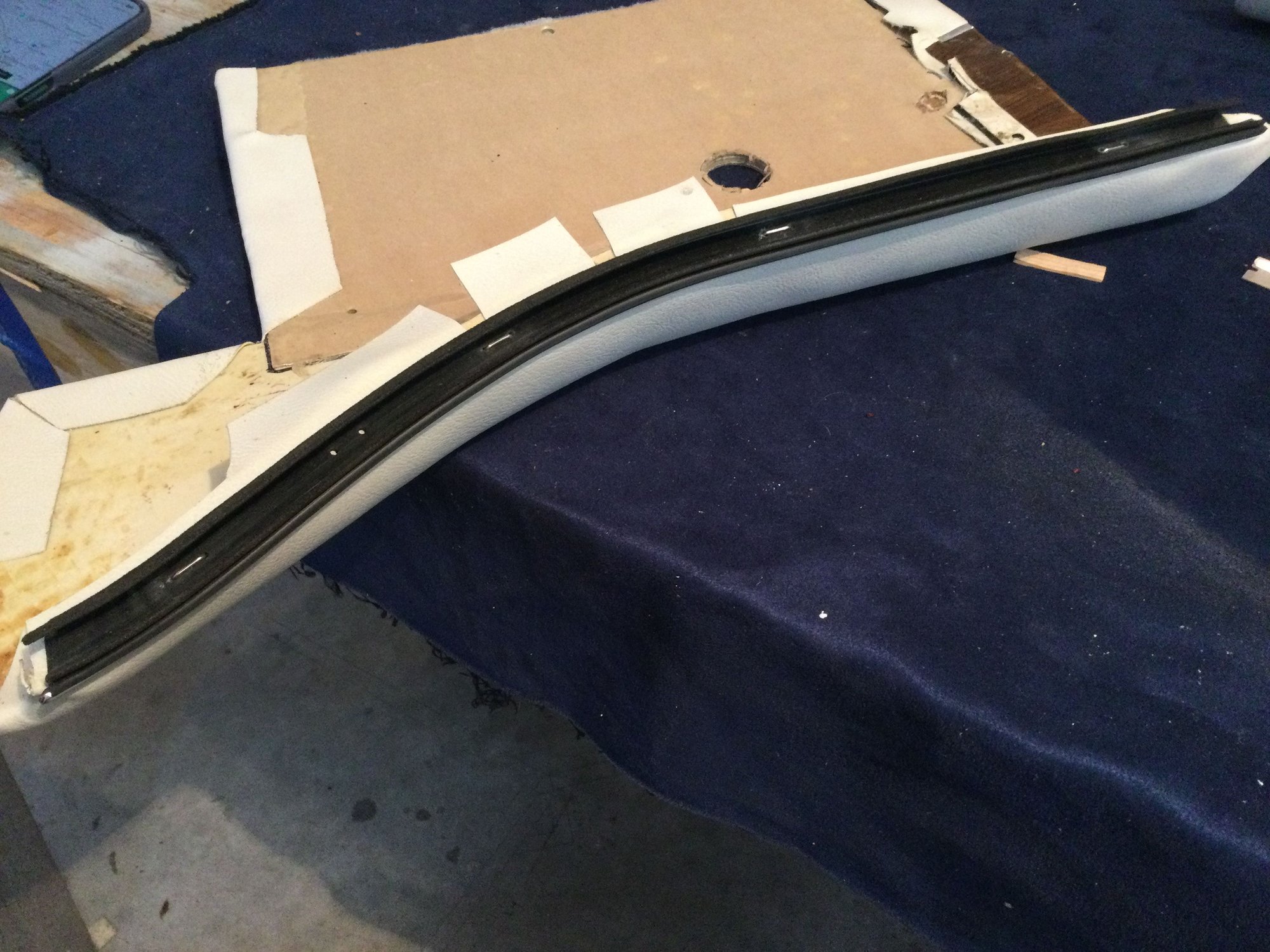 One of the meanest parts of this work is attaching the new interior glass belt line stripping.  It is done with stainless steel staples.  Touchy work to fit and drill through the prepunched holes into the fiberglass, and then trying to bend over the staples.  It is for sure doable, but not easy