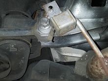 Customer exhaust hanger welded to the rear toe cam bolt