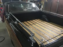 The wood bed I decided to add to give this unique car some extra character. The middle section is hinged, and I have extra storage underneath.