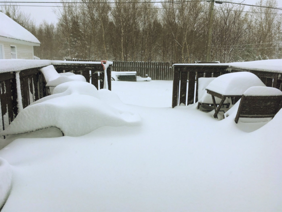 Snow piles up on a deck in Gander, N.L. on Thursday, May 24, 2018 in a handout photo. A late-spring storm that buried cars in snow and closed a slew of schools in Newfoundland was prompting dismay — and disbelief — from residents along the island's northeast coast Thursday. THE CANADIAN PRESS/HO-Randy Conners MANDATORY CREDIT