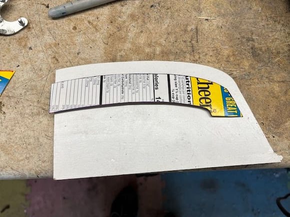 I made a cardboard template and transferred the curve to a piece of 3/16" plywood.  I used the plywood to hammer dolly the pocket into the patches where the tack strip goes.