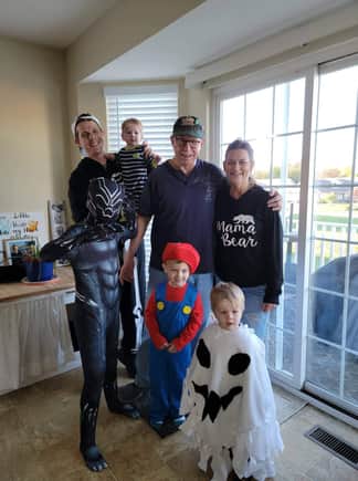 Back/Front; Left/-Right - Son-in-Law Mike with baby Anna, Grandpa, and Grandma; grandson's Gabe as the Black Panther, Keegan as Mario,  and Ollie as a ghost.  They were cute as hell!