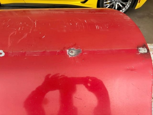 The SSBeltline trim attaches each end of door with screws.  Through a big hole, previously welded shut.  There are 5 more steel stud anchors across the door face.  I think they were resistance spot welded to the door skin, as I could not twist them off, easily.