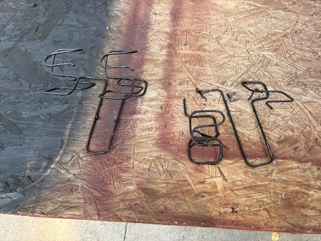 These are the end cushion springs.  It looks like they perhaps were replaced once already?  Not real sure about that.  One side was broken in two places, other side was OK.