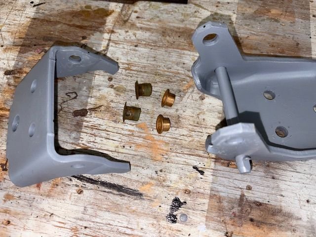 This is the top hinge.  New bronze bushings, two of them same size.  The old nylon bushings totally worn out for comparison.