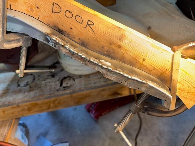 I liked the fit, so welded it up, ground it down, filed a radius on the front side to match original profile.  Cleaned it all up, reprimed with epoxy to protect while I finish the left door and fender.