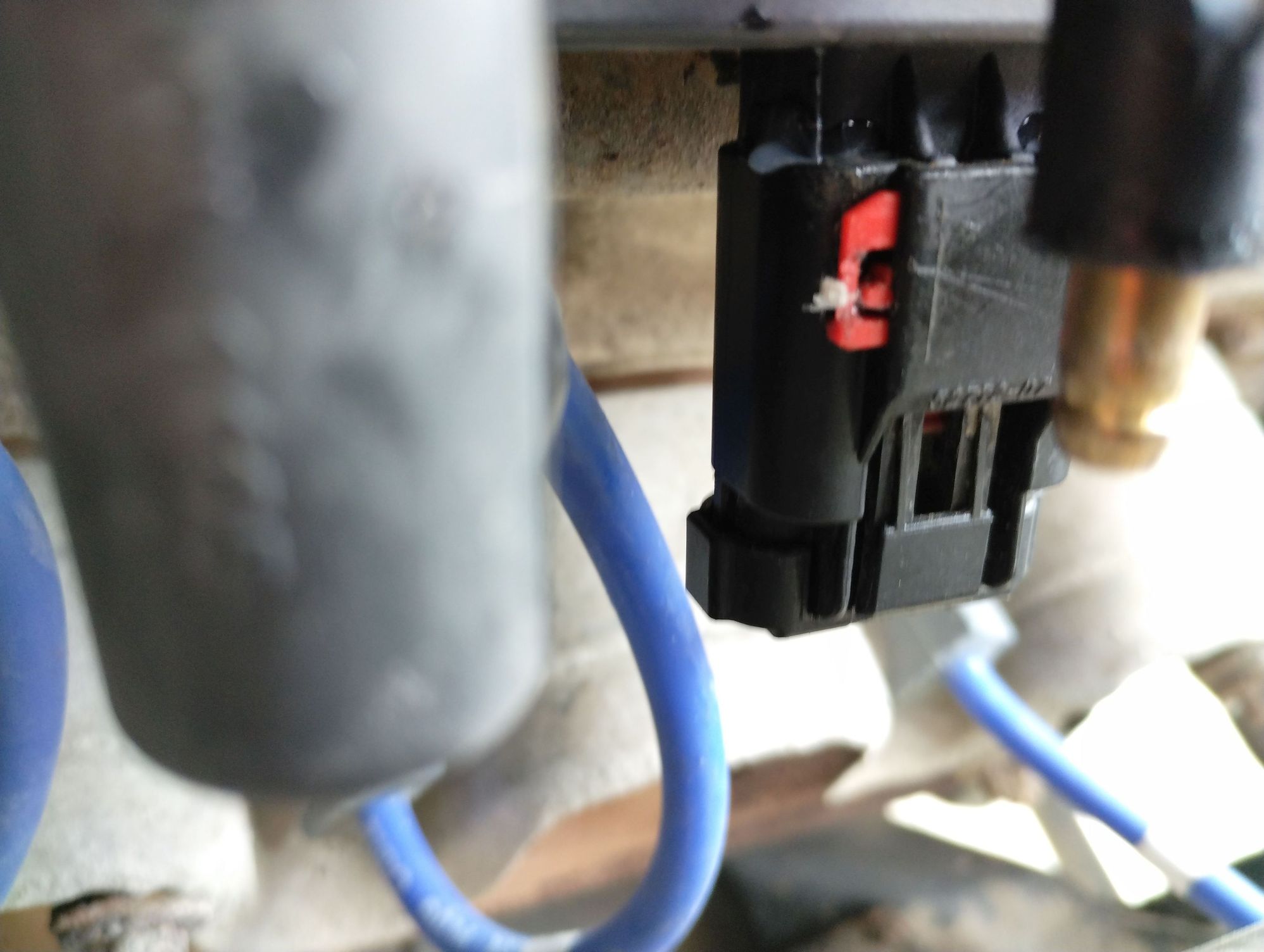 This is what your fighting. See that tiny red tit peeking out? Use a small dental pick to very carefully pull it DOWN while you simultaneously push UP on the plug, then push the red 