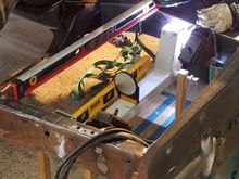 Here is Stephen welding it in. The wooden sticks have a hole set at the height I needed the cross member to be at. Worked great. The cross member is close to the motor mounts, so we need smaller torch cups to get it the tight space.