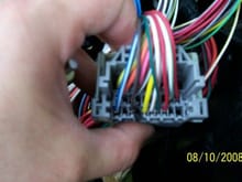 Remove the electrical tape and the rubber boot from the connector. right by my thumb there is a terminal outlined in black if you are counting them then it is the fourth one from the left with the open end of the connector facing you.