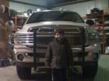 my little buddy robbie ( my only little brother) i front of my dads trck jsut after putting his lift on