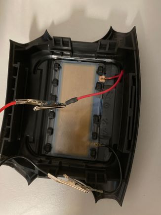 This is the back of the steering wheel pad.  You can see the test clips attached to the two wires.