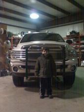 my little buddy robbie ( my only little brother) i front of my dads trck jsut after putting his lift on