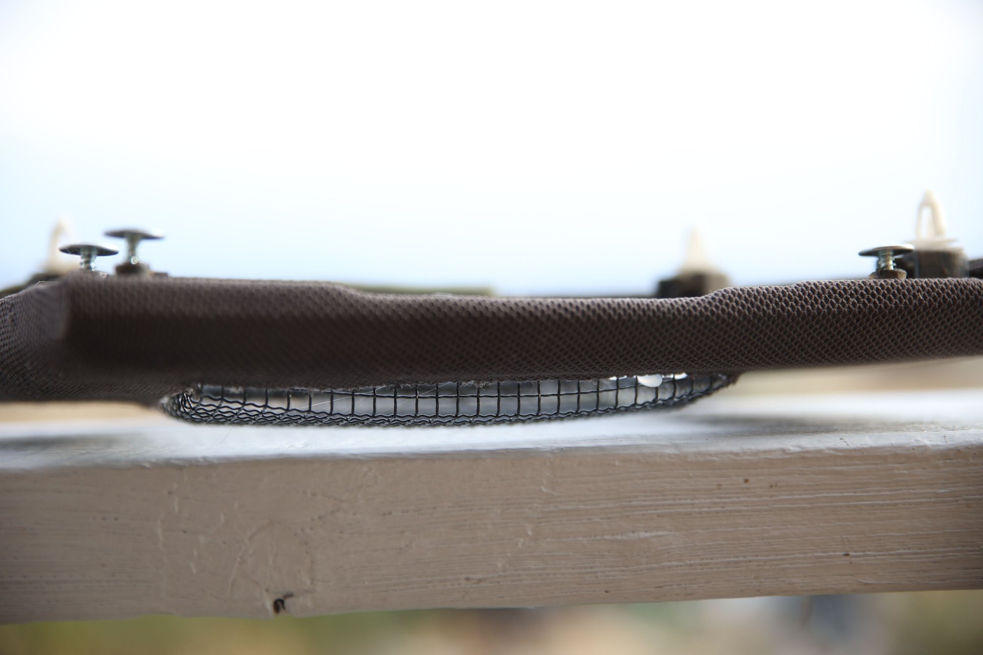 Wire protrudes from the speaker cover.