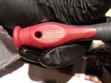 Uses 3mm wide flat head screwdriver to open the cramp holding the plastic cap