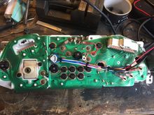 This is the rear of the cluster all wired up. I was able to steal power and tach signal from the stock cluster board so there won't need to be additional wiring. Also as I'm sure you can tell the plug socket that was originally flush mounted had to be cut out and mounted outside to accommodate the Ultra tach. Also you can see where I was able to mount the new bulb that lights the two center gauges.