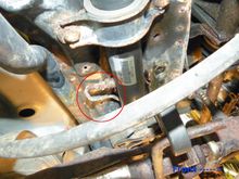 It's above the catalytic converter tucked under the rear cross member.