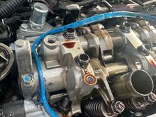 this is what i found when removing my valve cover, the loose bolt in the picture belongs in the hole just above it, i put lock tight on the bolt and that fixed my issue