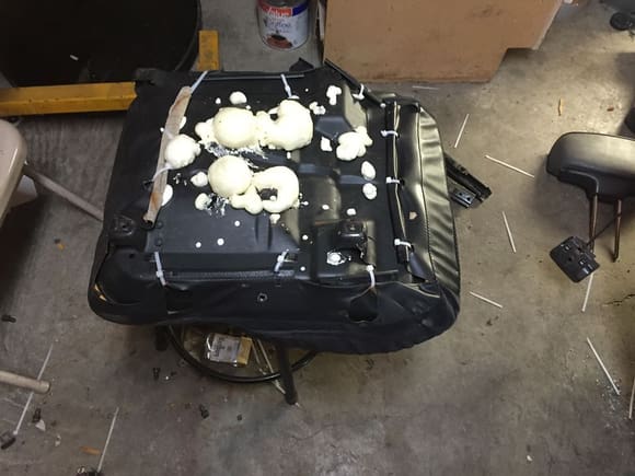 Spray foam insulation in driver's seat pan