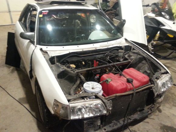 what the car looked like pulling it into the shop.  sold the hood and front bumper to a friend.  you can see more of the builders "ingenuity" with the boat tank up front