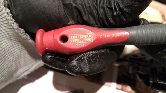 Uses 3mm wide flat head screwdriver to open the cramp holding the plastic cap
