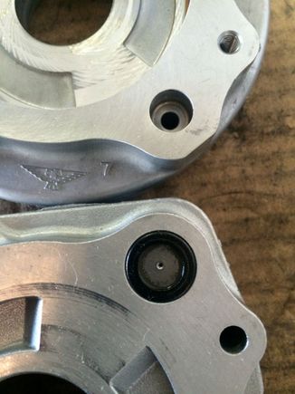 On the top is the piston housing and the where the fluid would normally exit. On the bottom is the "middle" plate with the regulating orifice. That will have to be blocked as well.