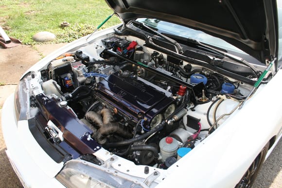 Engine bay of a DC2 Chassis with Koyo half sized radiator, GT30R and Garrett single back door intercooler