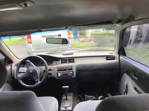 from the backseat, top light doesn't work, steering wheel is crooked to the right 70% and a busted air vent but it could be a looot worse